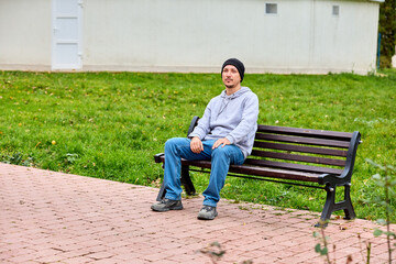 Fototapeta premium Man sits calmly on park bench