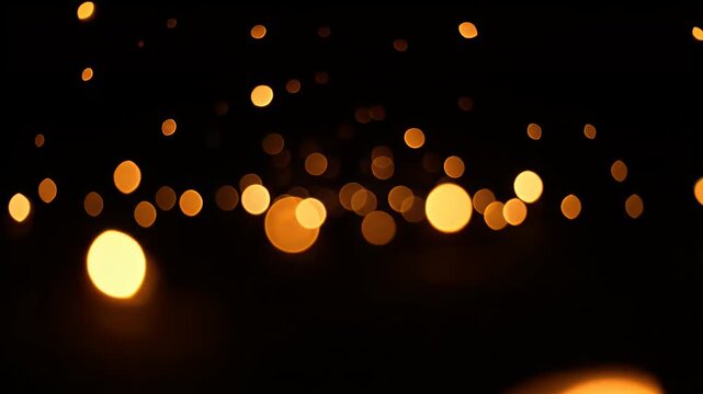 A dark backdrop with numerous bokeh circles, in shades of yellow and orange, floating randomly