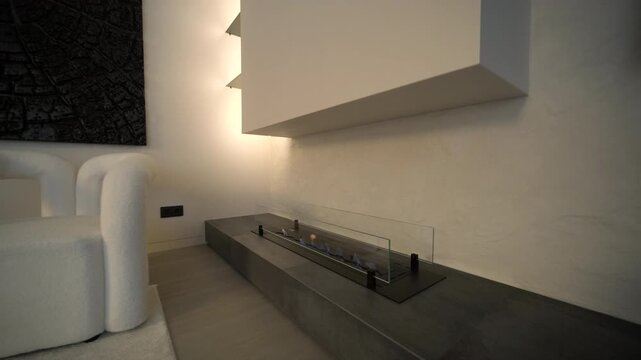 Modern minimalist living room with linear bio fireplace and white boucle armchai