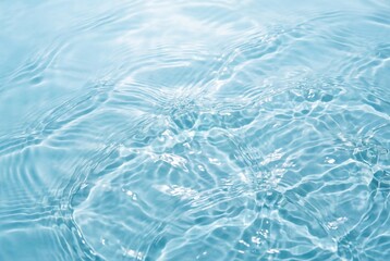 Obraz premium Fresh blue water surface texture with gentle waves and sunlight reflection for summer concepts