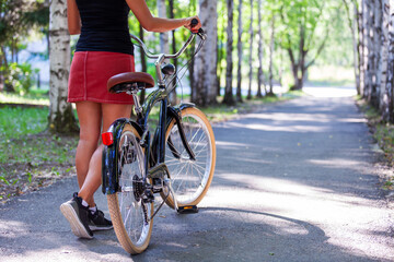 adult woman riding a bike in a summer park