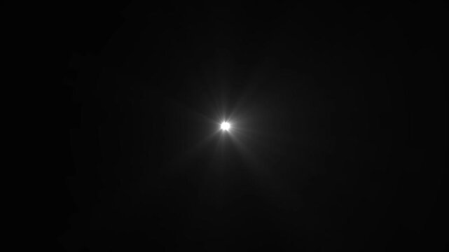 Bright white starburst light in center of black background