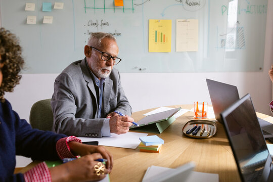 Meeting With Team in a Conference Room Discussing Projects