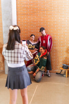 Students posing while being photographed by classmate