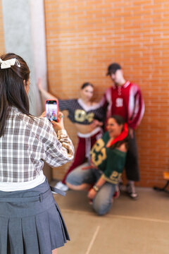 Students posing while being photographed by classmate