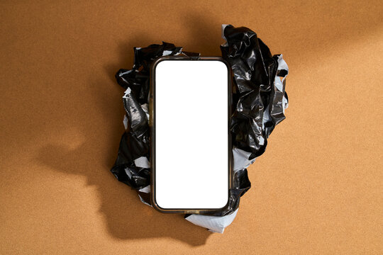 Still Life of Phone on Ball Made With Black Tape on Brown Background