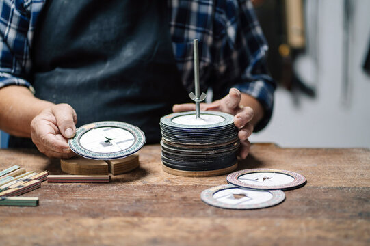 Luthier creating guitar rosette in workshop