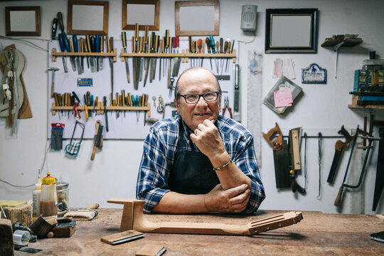 Luthier crafting musical instruments in his workshop