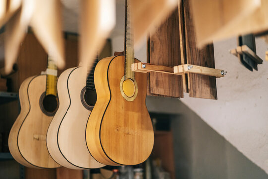 Guitars hanging in a luthier workshop ready for completion