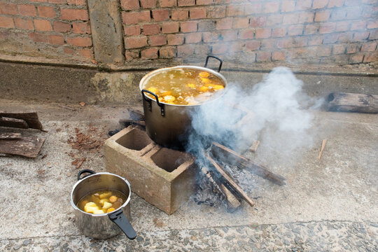 Large Pot Cooking Sancocho Outside With Smoke Rising From Fire
