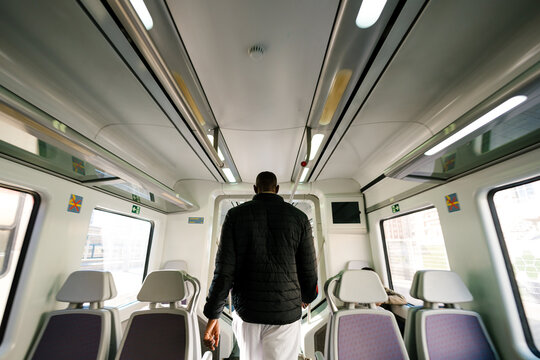 Anonymous passenger walking inside a train