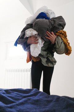 Person carrying huge pile of clean laundry