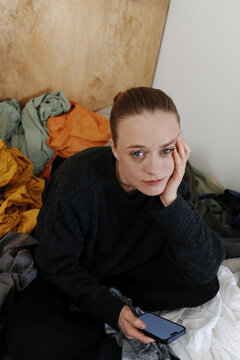 Woman feeling tired and bored in a messy home