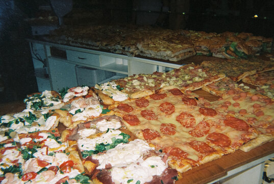 pizza al taglio displayed in an Italian takeaway, 35mm film