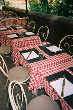 outdoor restaurant tables with checkered tablecloths, 35mm film