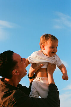 Father Lifting Happy Baby Blue Sky Film Photo