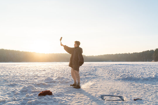 Man Filming Himself Before Bathing In The Ice Hole
