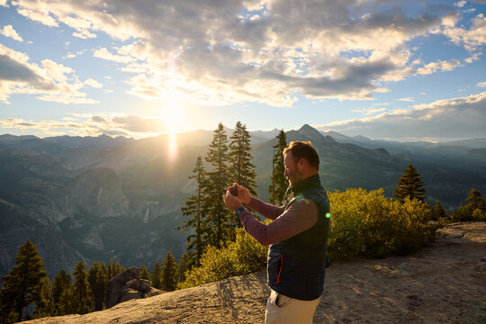 Man takes scenery photos at sunset