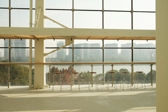Window view from a cafe with bar stools facing a city skyline
