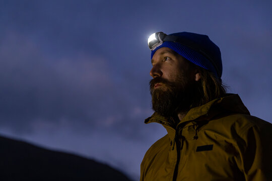 Portrait  hiker with headlamp in dark 