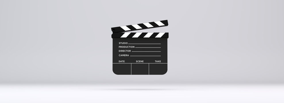 Classic black movie clapperboard front view on a light grey studio background. Professional film slate for cinema production, video editing, and broadcasting industry.
