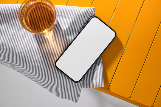 Smartphone and Drink on Striped Cloth