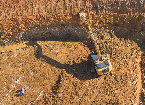 Aerial Excavator Digging Deep Construction Pit