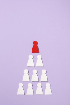 Red figure stands out from a pyramid of white figures