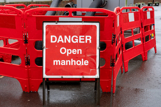 Warning Sign and barriers around an open manhole