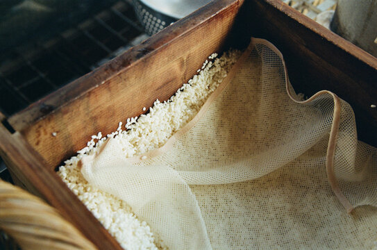 Mochi Rice Preparation Takes Place in a Wooden Box With a Cloth Cover
