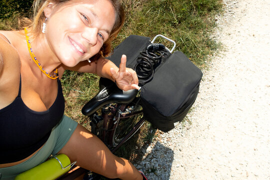 UGC tourist giving peace sign on gravel road