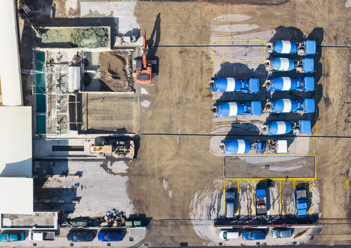 Aerial Top-Down View of Cement Plant with Concrete Mixer Trucks