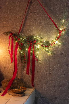 Festive Evergreen Garland with Red Ribbons and Lights