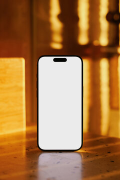 Smartphone mockup standing on table in sunlight