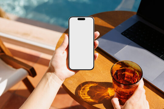 Smartphone mockup with white screen at summer hotel pool
