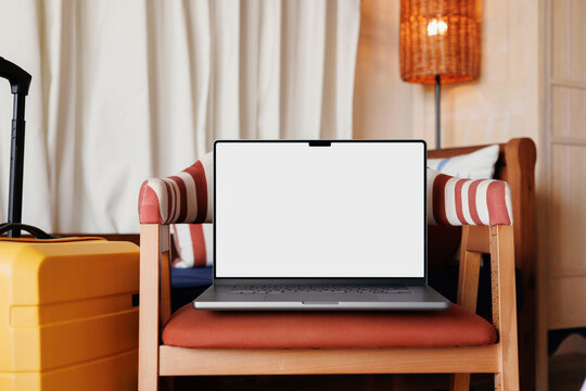 Laptop with white screen and travel suitcase mockup