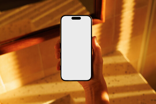 Phone with white screen in warm indoor light Mockup