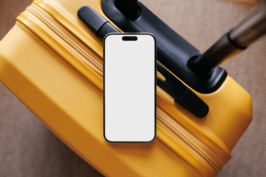 Travel phone mockup with white screen on yellow suitcase