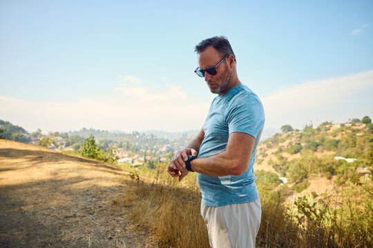 Active man checks the pace on his watch