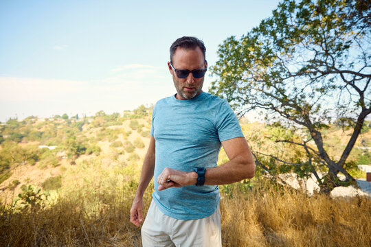 Active man checks the pace on his watch