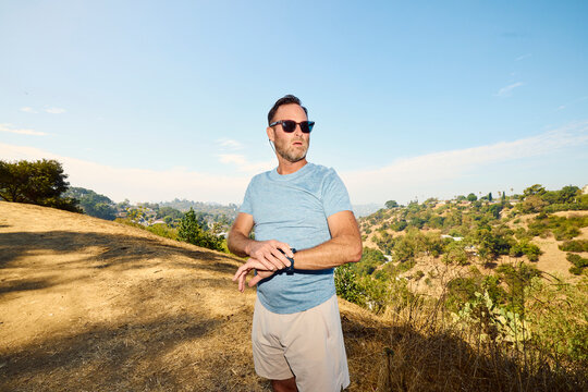 Handsome man works out in the countryside