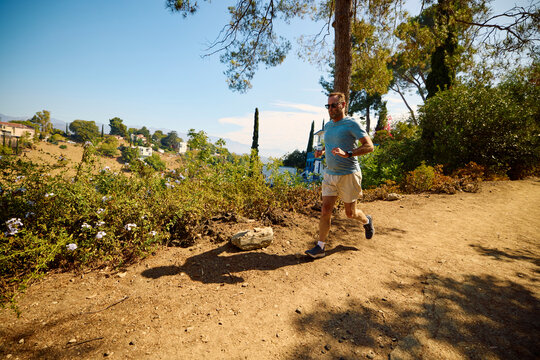 Man runs down a dirt path.