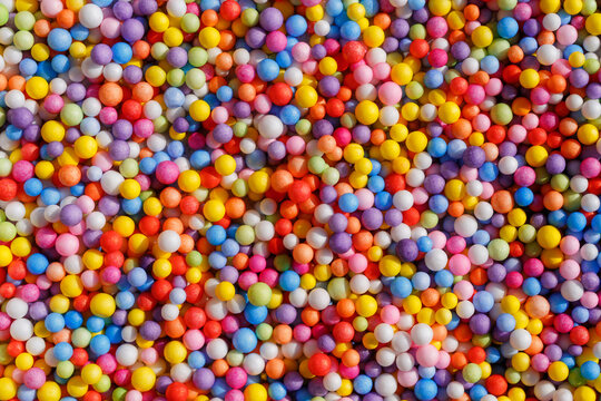 Colorful Collection of Small Round Balls on a Flat Surface