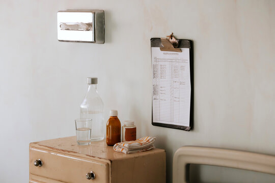 Hospital bedside essentials with clipboard and bottle