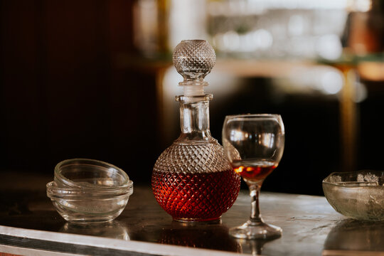 Elegant crystal decanter set on bar with glassware