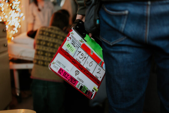 Film set with clapperboard and crew members in action