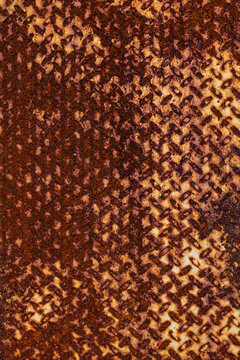 Close-up of rusted textured metal with deep brown hues