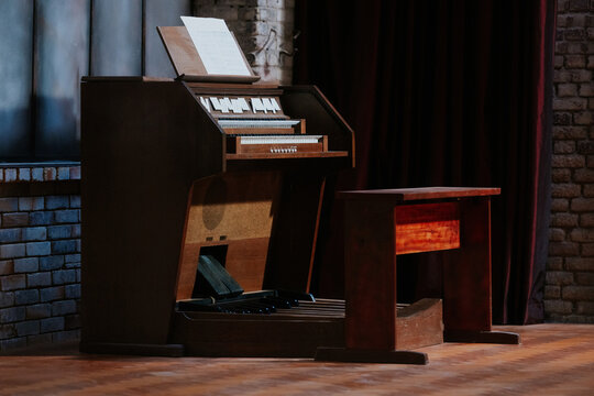 Vintage wooden organ in dimly lit room