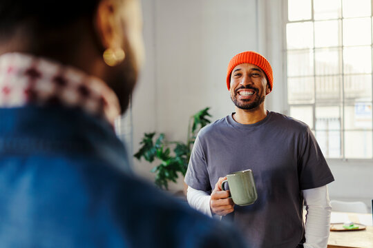 Happy man having relaxed conversation on coffee break