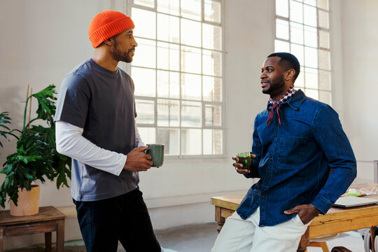 Two men having a casual discussion in modern office